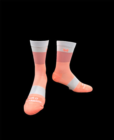 The ”Trio White, Pink and Salmon ” is a 6" men and women's cycling and running sock with compression.